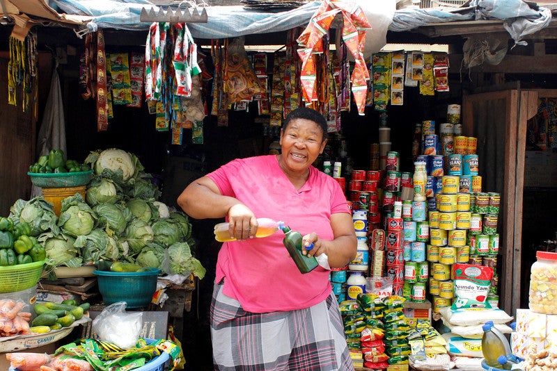 A woman smiles at a local market