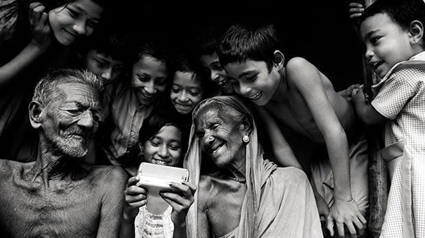 A family uses a mobile phone in India