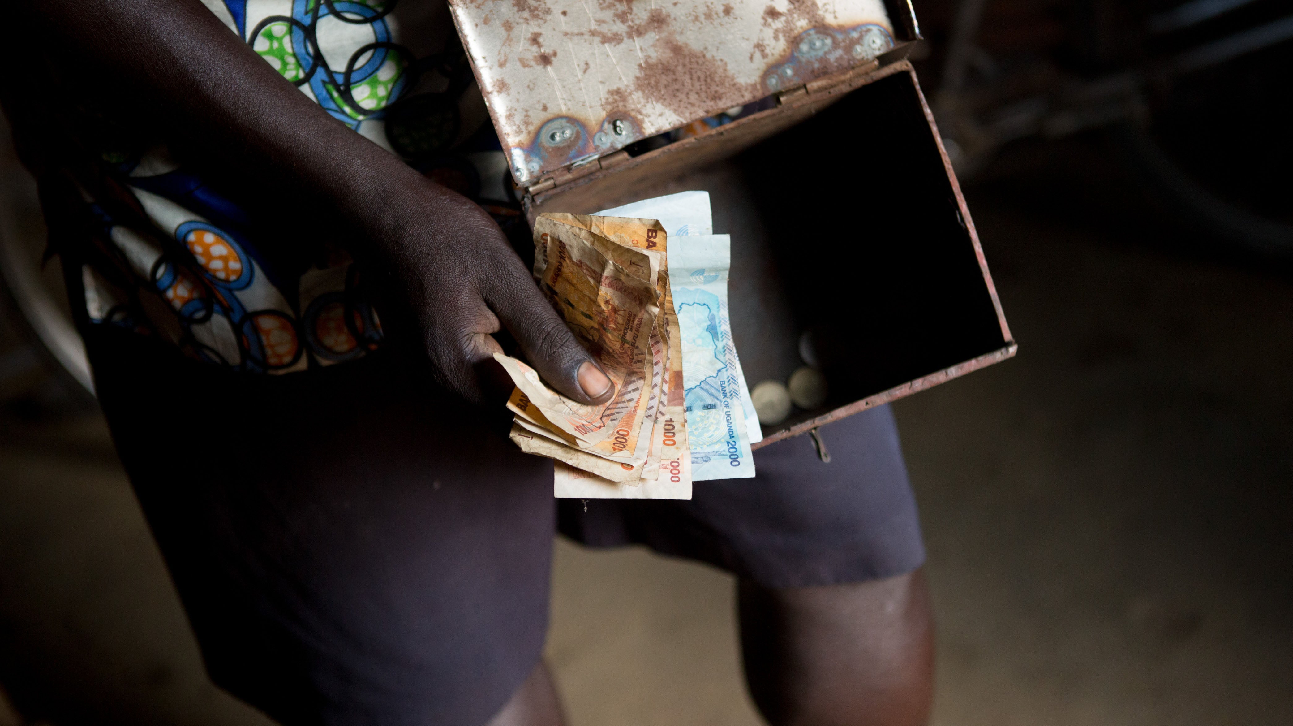 A person holding a box of money.