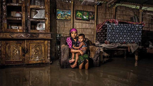 Mother and child in flooded home
