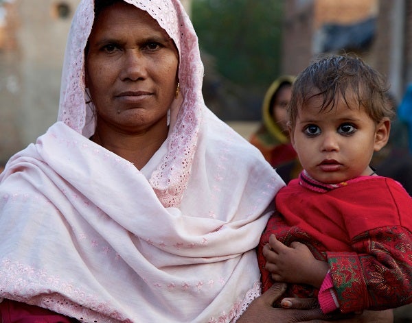 Woman holding child, India