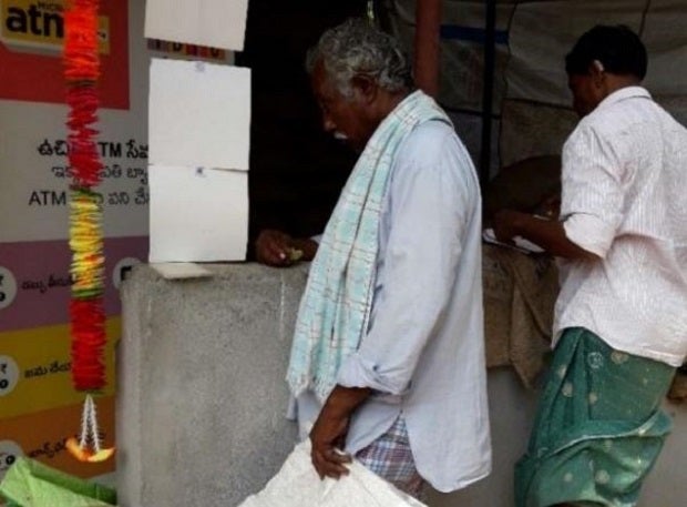 Man at mini-ATM in Royyuru