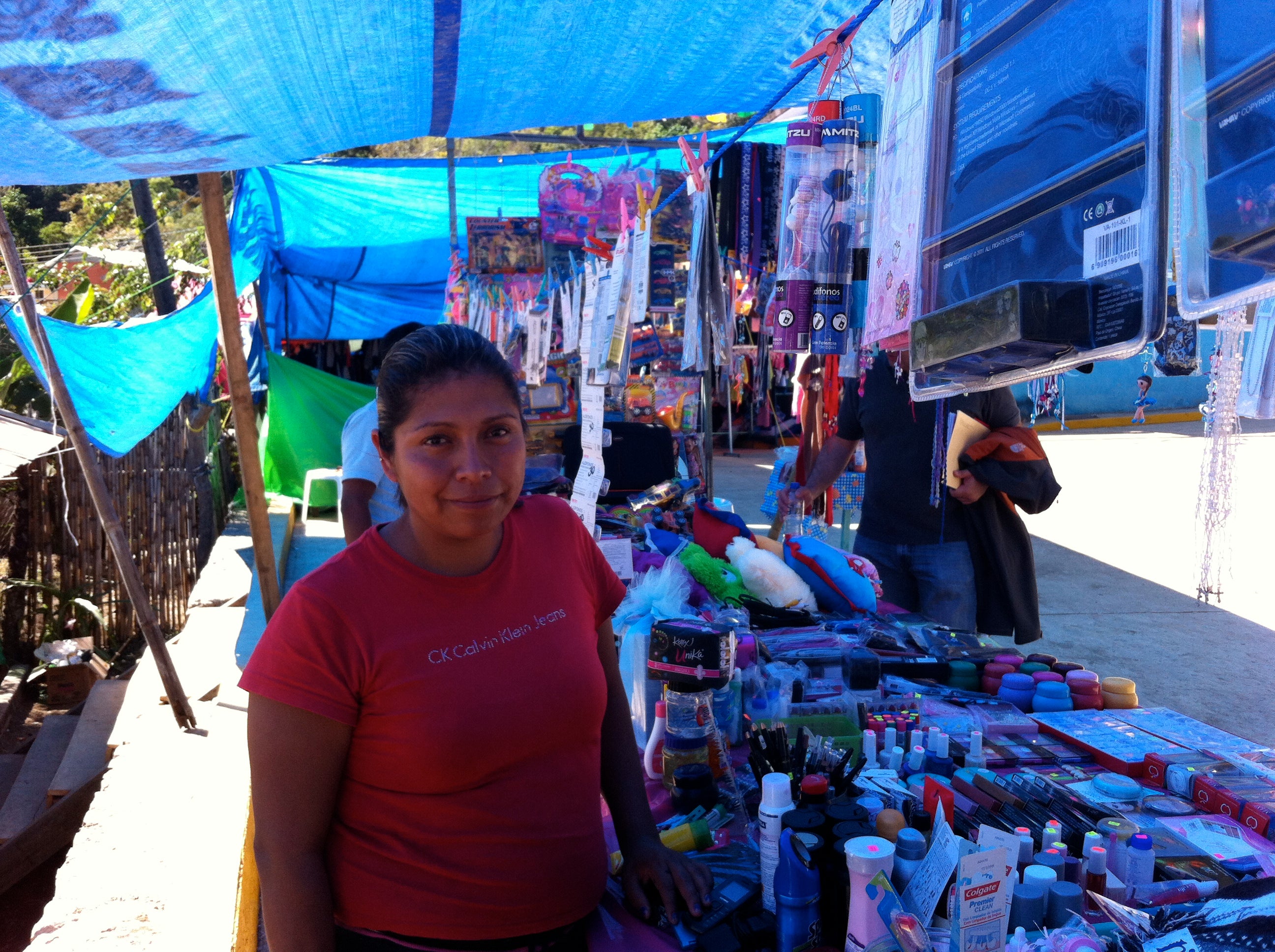 Lady stands in a market in Mexico
