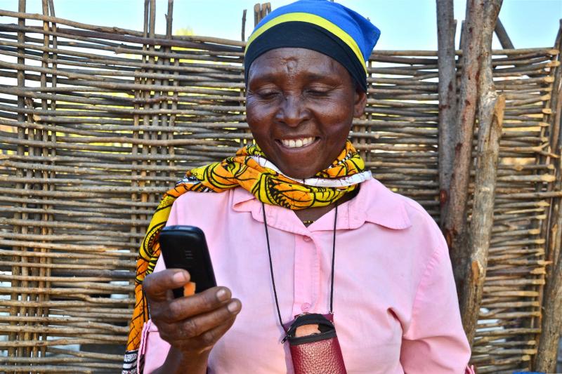 Woman uses mobile phone in Kenya