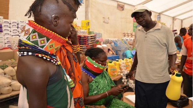 Lolem, a widow and mother of four children, sells goods to Bamba Chakula recipients in a refugee camp in Kenya.
