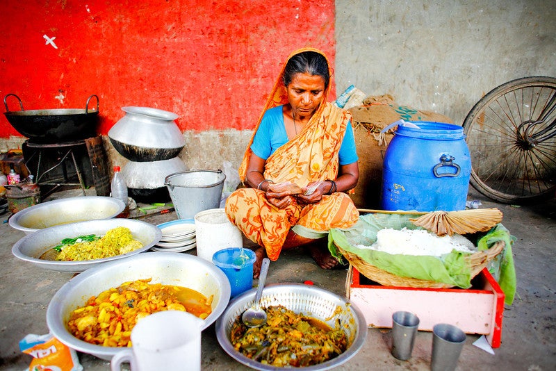 A lady sits at her micro restaurant.