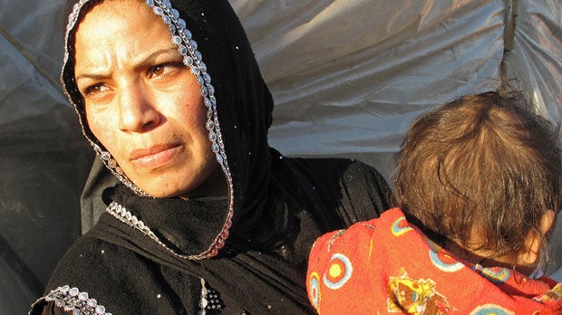 Sabah and her young child in Al Minieh Informal Tented Settlement, North Lebanon.
