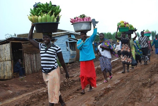 Women bring their farm products to a market in Uganda.