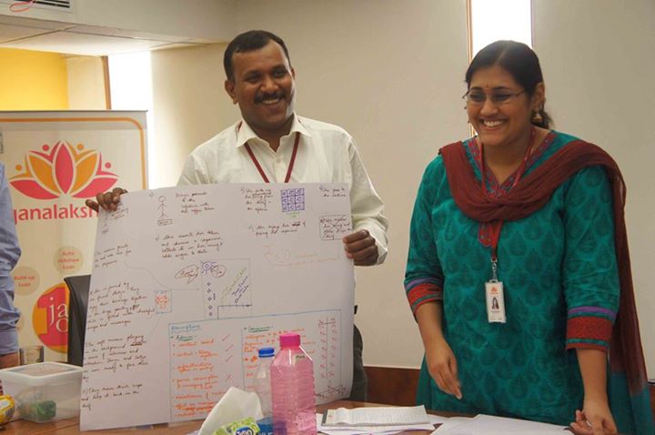 Janalakshmi staff members smile togther at a workshop.