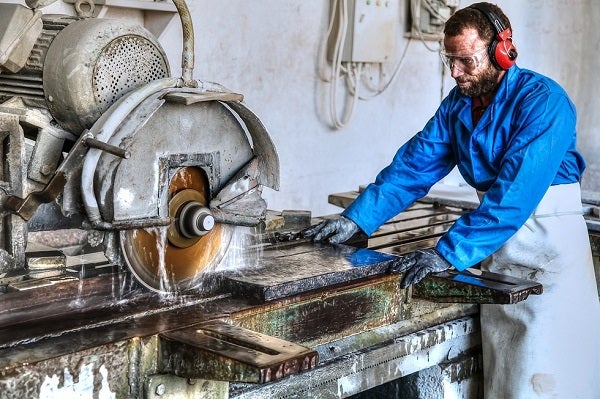 Man cuts marble with a power saw, Jordan