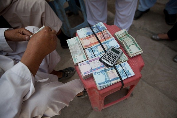 A money changer works in Afghanistan