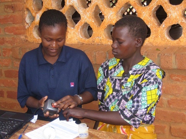 Two women use biometric identification.