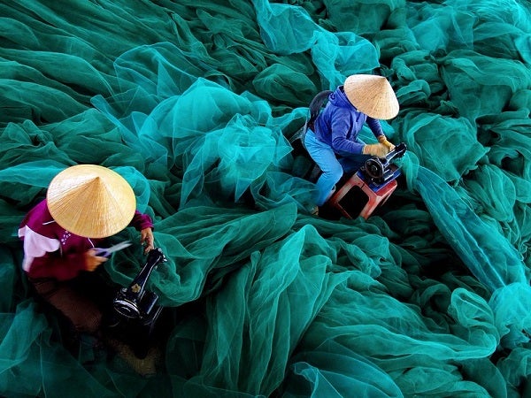 Women prepare fishing nets for their husbands' next ocean journey.