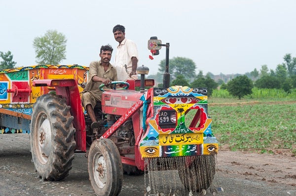 Two farmers work with Wasil Foundation to purchase a tractor in Pakistan