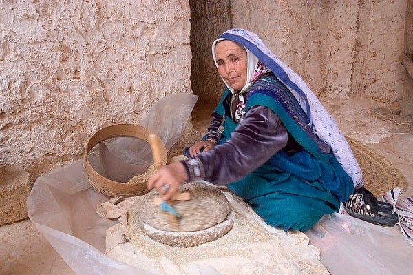 A woman in Tunisia makes flour
