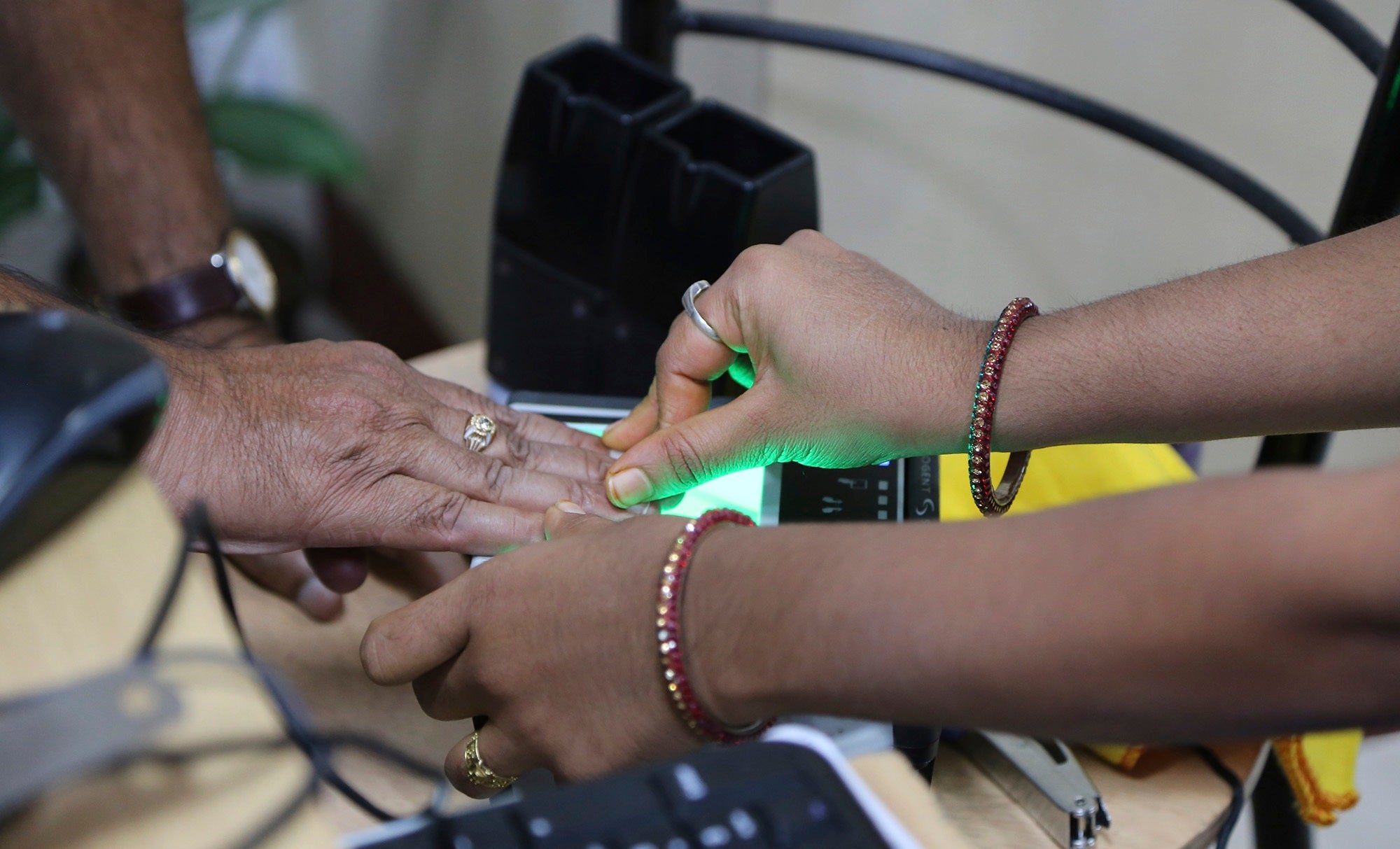 A man scans his fingerprints for the Aadhaar program in India