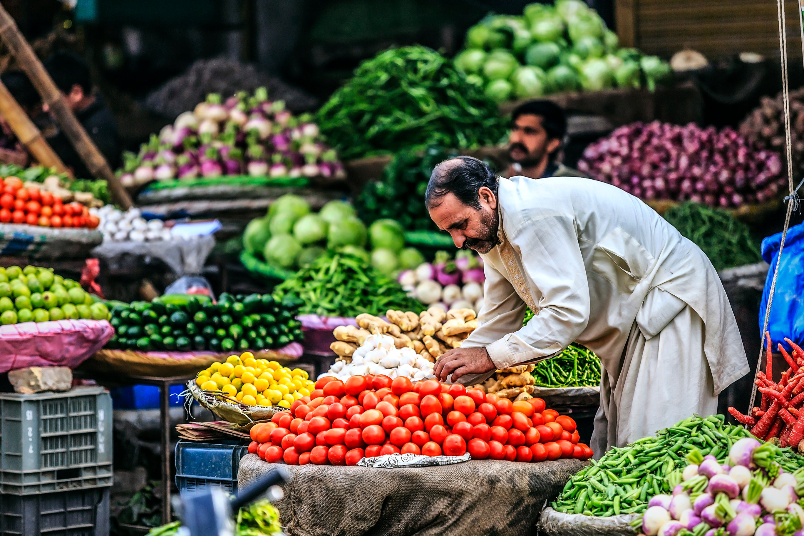 A man at the vegetable market. Photo by Faryab Shakh