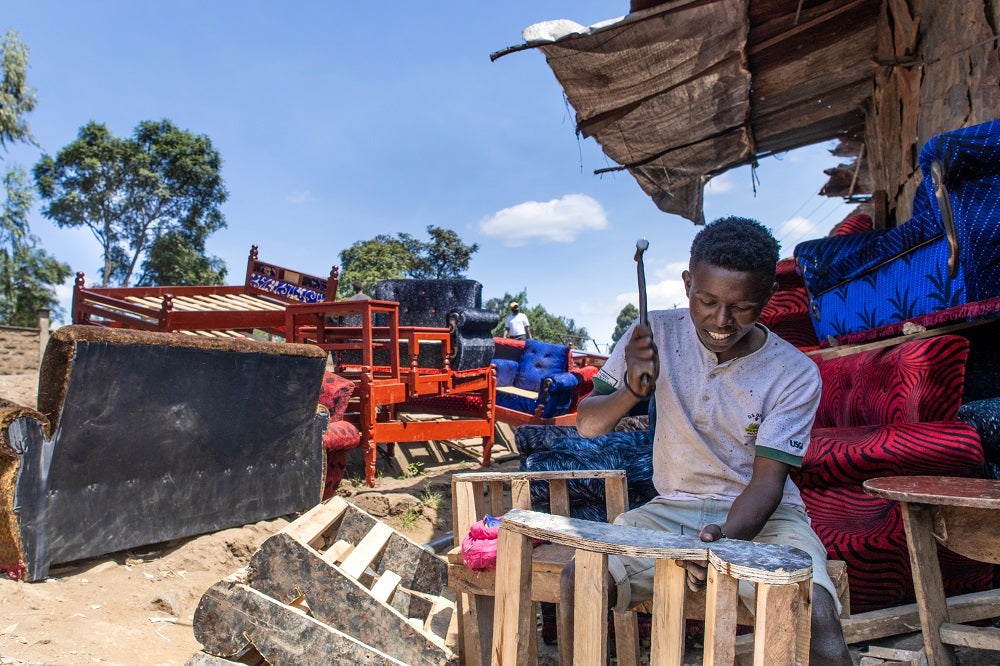 A carpenter works with his hammer in Nairobi, Kenya