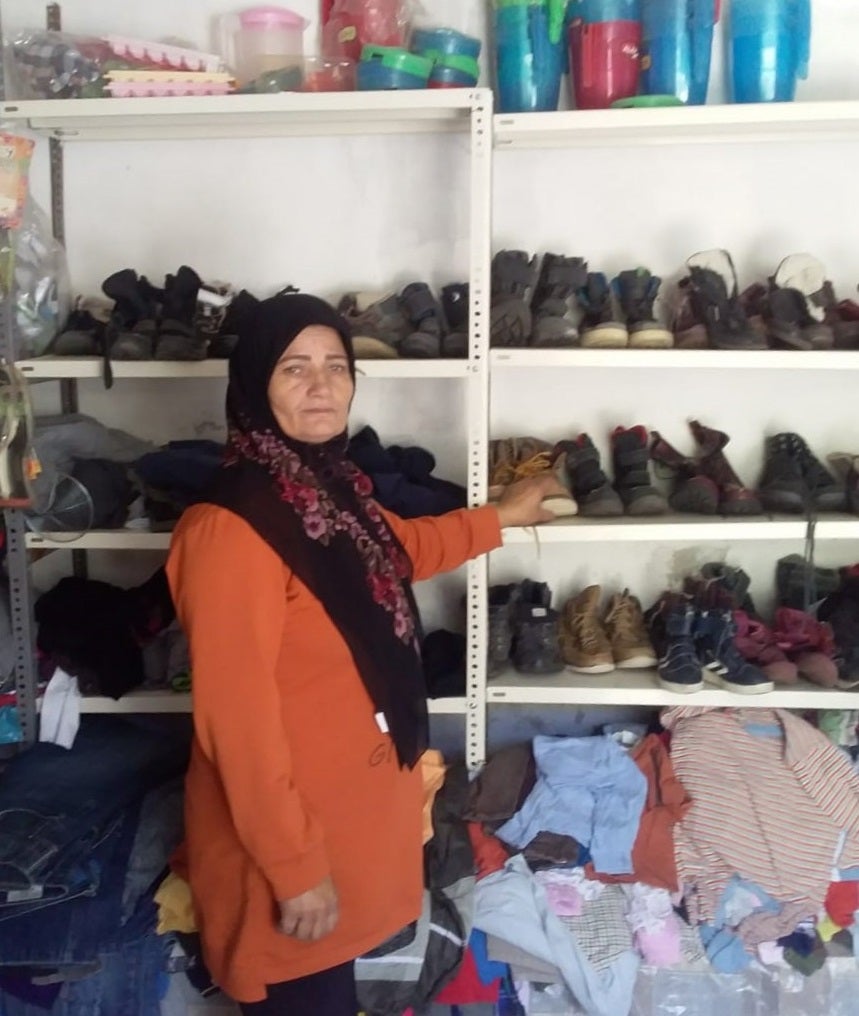 Feryal, one of the borrowers who participated in CGAP’s study, organizes her second-hand clothing store in the Beqaa valley.