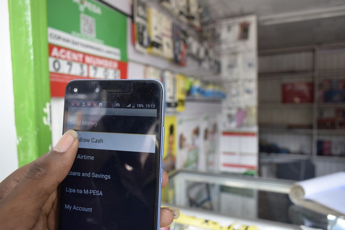 An M-Pesa customer withdraws cash using app in Kenya