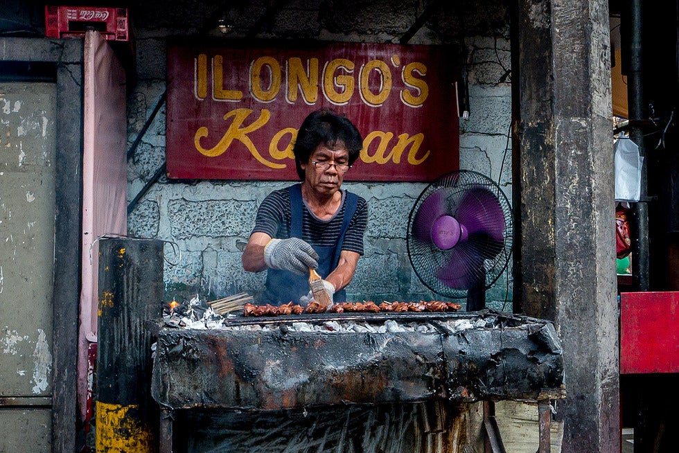A food vendor in the Philippines as his grills pork for his customers every day. Photo: Froi Rivera, 2015 CGAP Photo Contest 