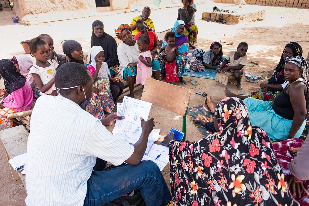 A representative of a microfinance institution meets with prospective borrowers in Siby, Mali. 