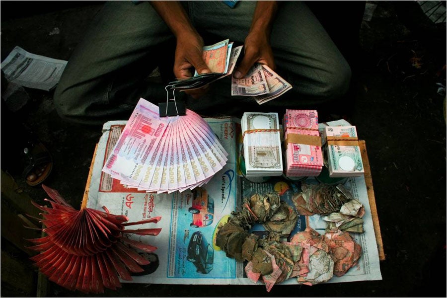 This money changer in Bangladesh exchanges heavily used, torn notes for new ones. Photo: Mohammad Moniruzzaman, 2009 CGAP Photo Contest