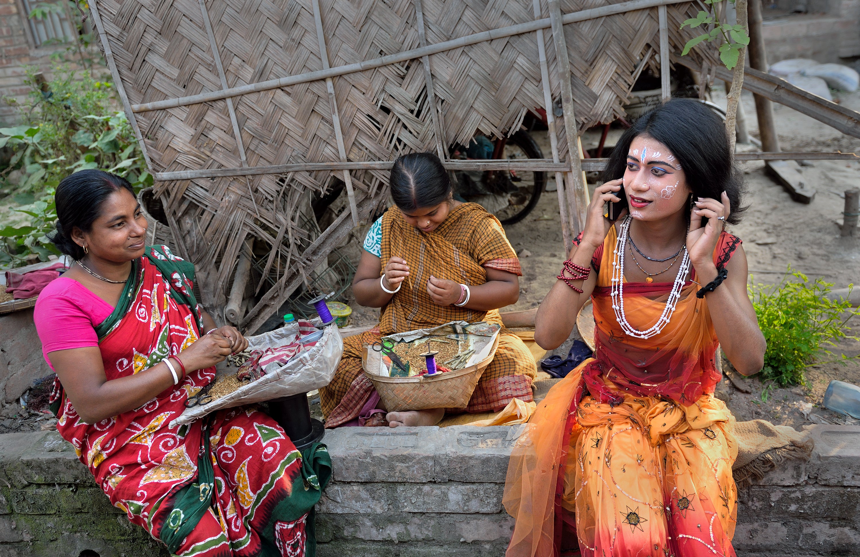 A merchant uses her mobile phone in India