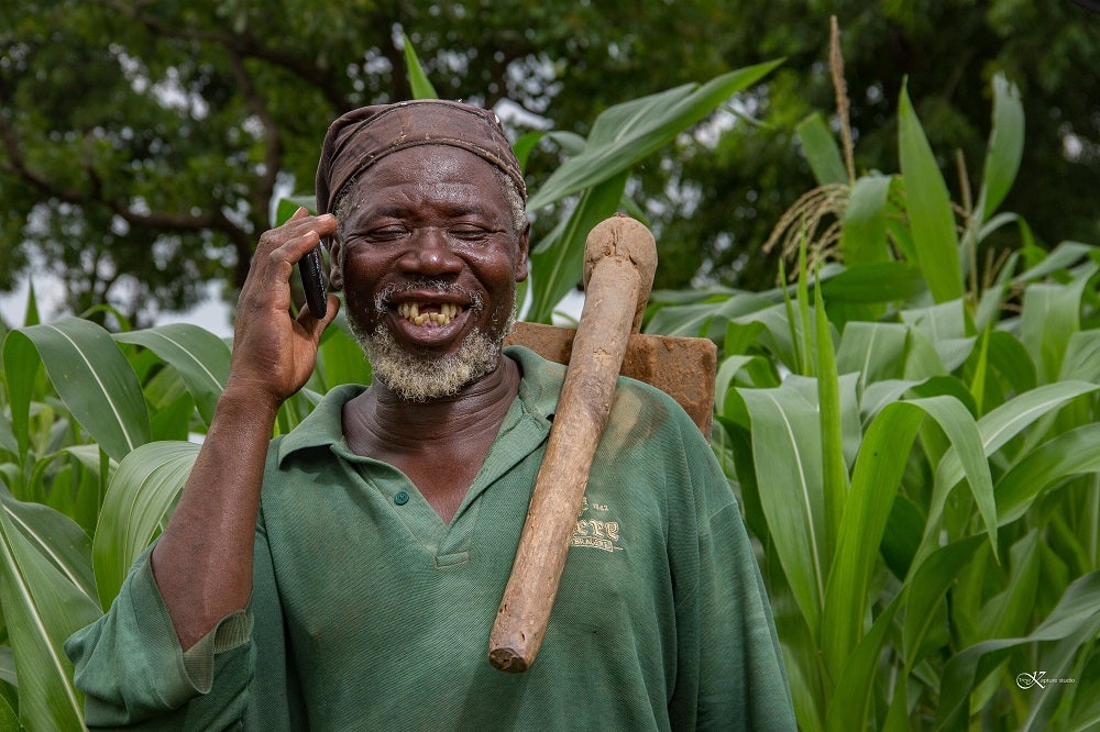 A smallholder farmer in Ghana uses his mobile phone.
