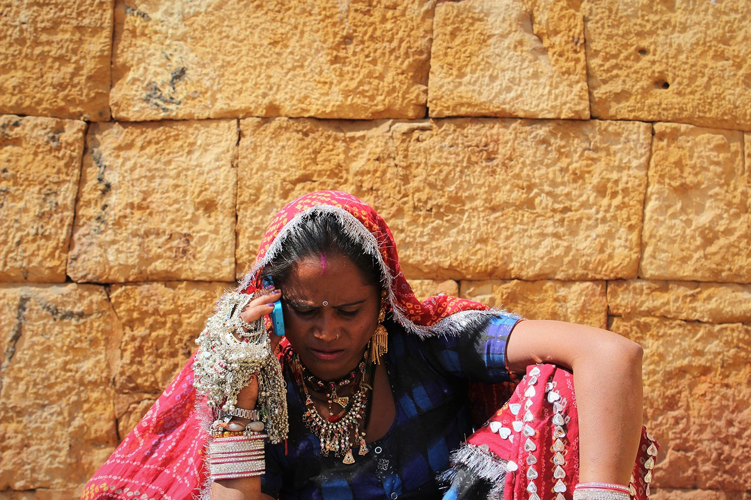A merchant uses her mobile phone in Jaisalmer, India.