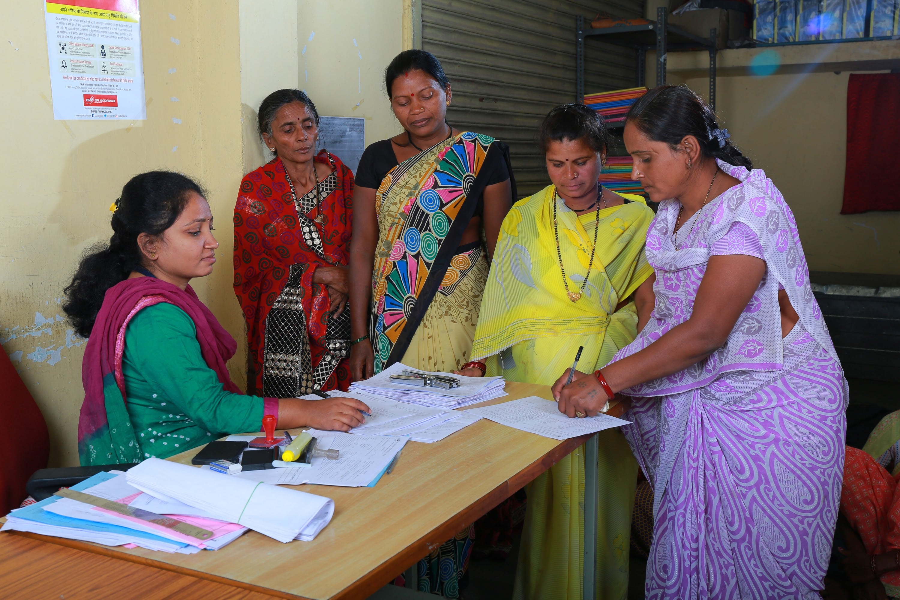 Women in India apply for a bank loan to start a business.