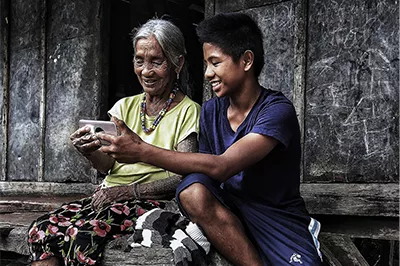Household uses mobile phone in village in rural Philippines