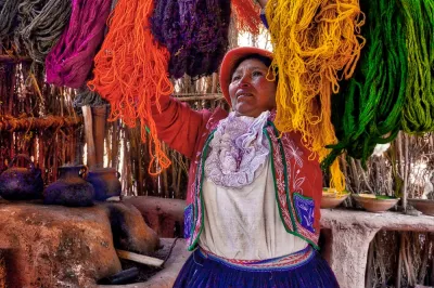 Woman dyeing wool in Peru
