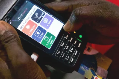 a man holds a handheld payment device