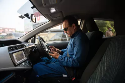 A driver looks at his phone