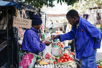 A vegetable vendor sells to a customer in South Africa