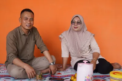 An Indonesian man and woman eat at home