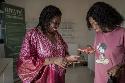 two African women looking at their phones