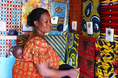 A woman at work with her baby on her back