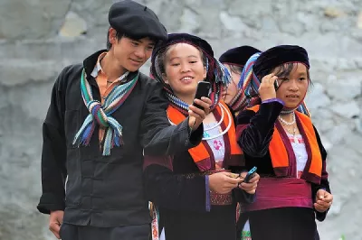 Children in Vietnam use their mobile phones.