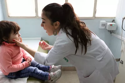 Registered nurse vaccinates a child for polio in Beirut, Lebanon