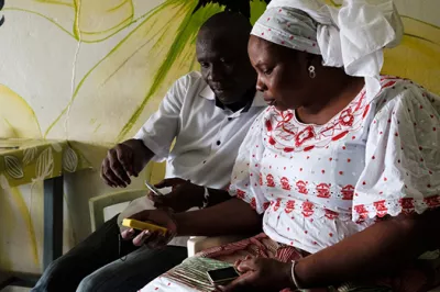 A woman makes a mobile money transfer