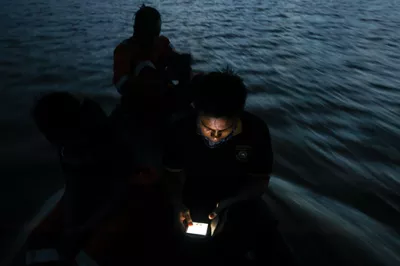 Fishermen use a mobile app to locate fish in Indonesia.