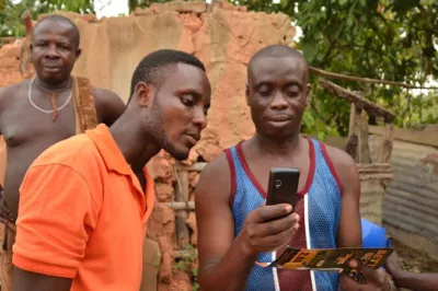 Mobile money users looking at a mobile phone.