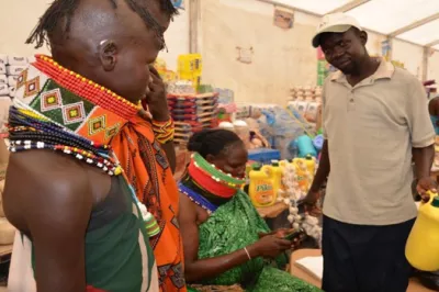 Lolem, a widow and mother of four children, sells goods to Bamba Chakula recipients in a refugee camp in Kenya.