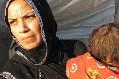 Sabah and her young child in Al Minieh Informal Tented Settlement, North Lebanon.