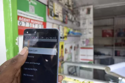 An M-Pesa customer withdraws cash from app in Kenya