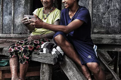 Family uses mobile phone in Philippine village
