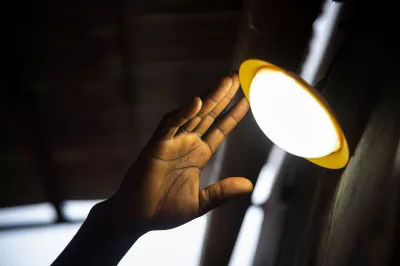Hand reaching for solar lamp at night