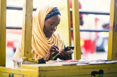 An agent uses her phone at a kiosk in Kenya. Photo: Kelvin Kariithi, 2018 CGAP Photo Contest